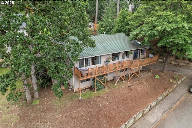 view of front of house with metal roof and a deck