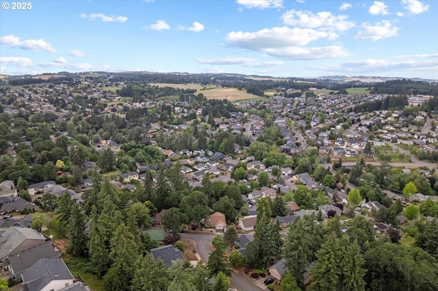 aerial view of property and surrounding area featuring nearby suburban area