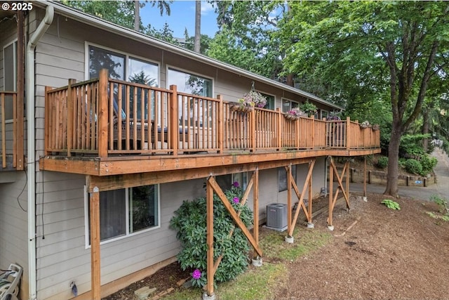 rear view of house with central AC and a deck