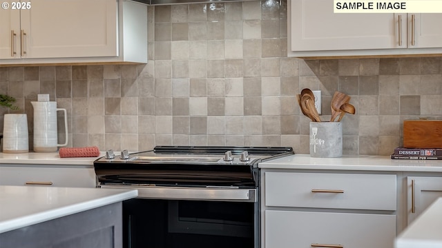 247 NW 29th Way, Battle Ground, WA 98604 - kitchen featuring stainless steel range with electric stovetop, backsplash, light countertops, and white cabinetry