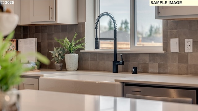 247 NW 29th Way, Battle Ground, WA 98604 - detailed view of light countertops, backsplash, white cabinetry, and a sink