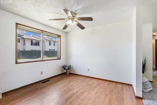 15605 SE 5th St, Vancouver, WA 98684 - spare room featuring light wood-type flooring, a ceiling fan, and a textured ceiling