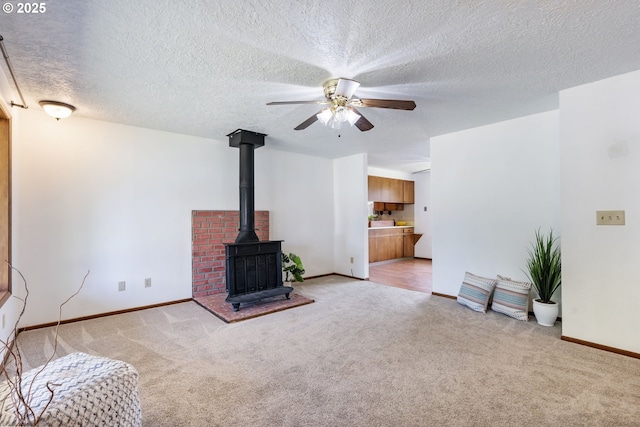 15605 SE 5th St, Vancouver, WA 98684 - unfurnished living room with light carpet, a ceiling fan, a wood stove, and a textured ceiling
