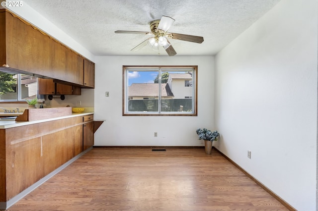 15605 SE 5th St, Vancouver, WA 98684 - kitchen featuring light wood-style floors, a textured ceiling, plenty of natural light, light countertops, and a ceiling fan