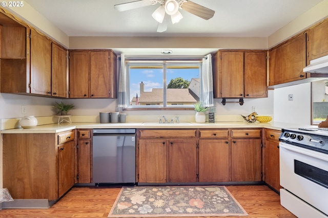 15605 SE 5th St, Vancouver, WA 98684 - kitchen with stainless steel dishwasher, white range, light wood finished floors, ceiling fan, and brown cabinetry