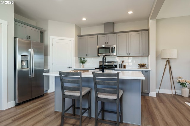 4027 SW Myrtle Aly Unit 7, Gresham, OR 97030 - kitchen featuring appliances with stainless steel finishes, gray cabinetry, and wood finished floors