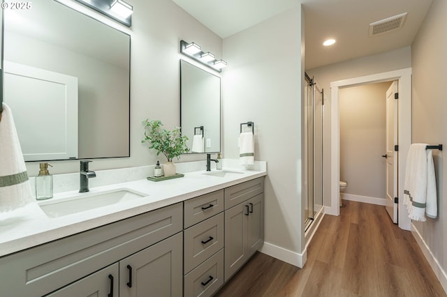 4027 SW Myrtle Aly Unit 7, Gresham, OR 97030 - bathroom featuring wood finished floors, visible vents, a sink, and a stall shower