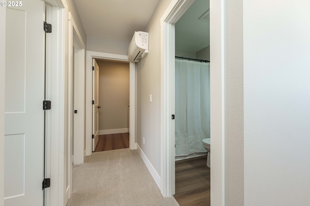 4027 SW Myrtle Aly Unit 7, Gresham, OR 97030 - hallway featuring a wall mounted air conditioner, baseboards, and carpet flooring