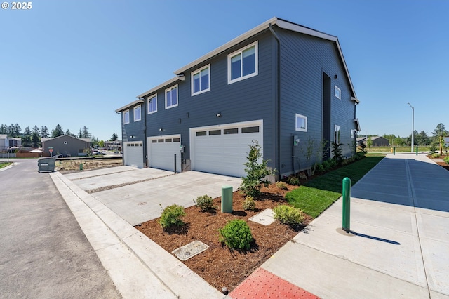 4027 SW Myrtle Aly Unit 7, Gresham, OR 97030 - view of property exterior featuring a garage and concrete driveway