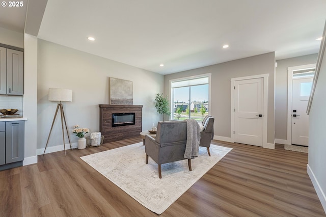 4027 SW Myrtle Aly Unit 7, Gresham, OR 97030 - living room featuring recessed lighting, a glass covered fireplace, wood finished floors, and baseboards