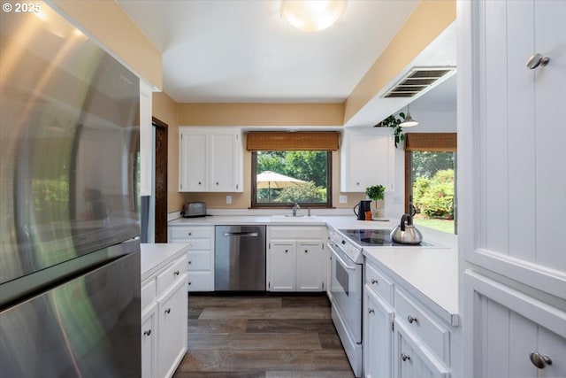 6567 Palomino Way W, Linn, OR 97068 - kitchen with appliances with stainless steel finishes, light countertops, white cabinetry, and dark wood-style floors