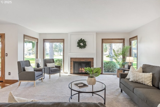 living room with a wealth of natural light and a brick fireplace