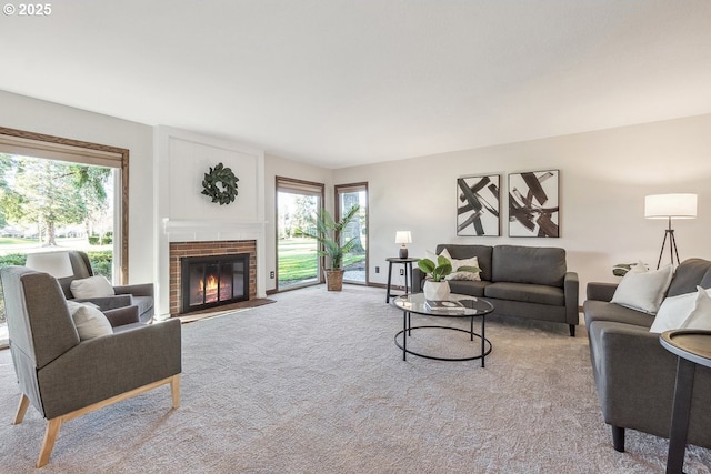 carpeted living room featuring a fireplace and a healthy amount of sunlight