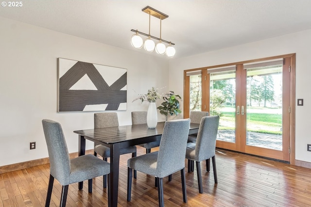 dining room with hardwood / wood-style floors and french doors