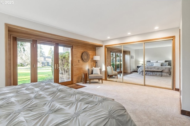 unfurnished bedroom featuring carpet flooring, a closet, access to exterior, and french doors