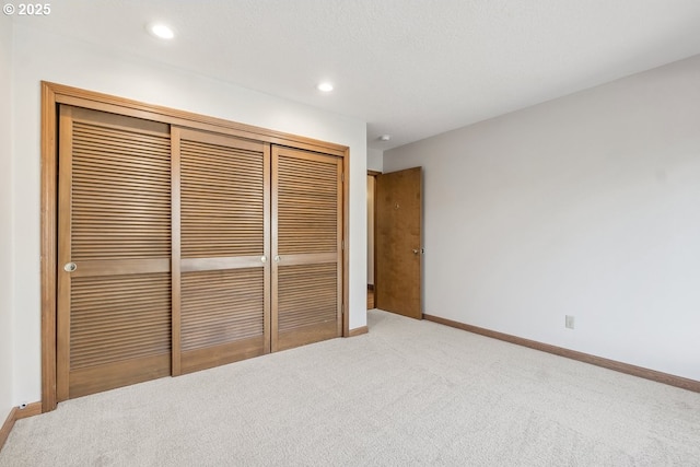 unfurnished bedroom with carpet flooring and a closet