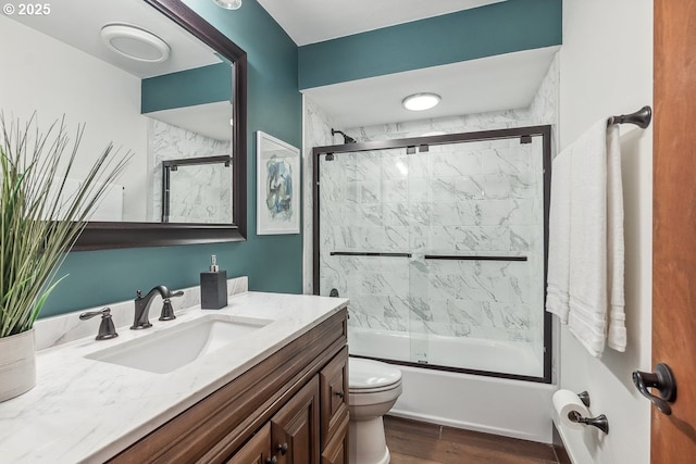 full bathroom with toilet, vanity, enclosed tub / shower combo, and wood-type flooring