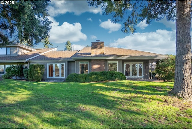 rear view of property with a lawn