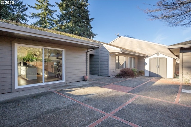 exterior space with a shed and a patio area