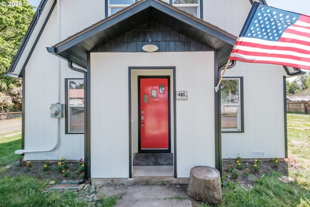 doorway to property featuring fence