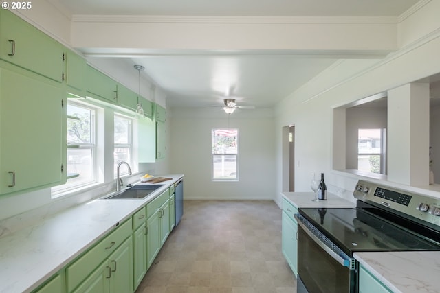 kitchen featuring stainless steel appliances, green cabinetry, a sink, and healthy amount of natural light