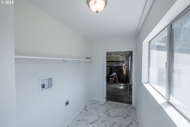 laundry room with washer hookup and light marble finish flooring