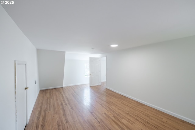 unfurnished room featuring light wood-type flooring and baseboards