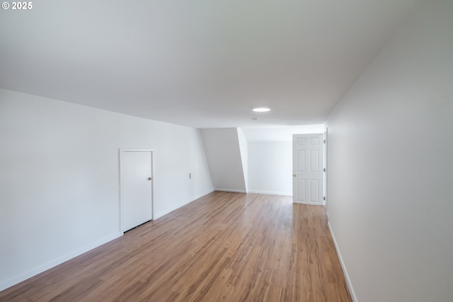 spare room with light wood-style flooring, baseboards, and recessed lighting