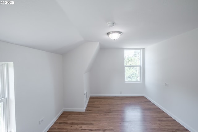 bonus room featuring vaulted ceiling, wood finished floors, and baseboards