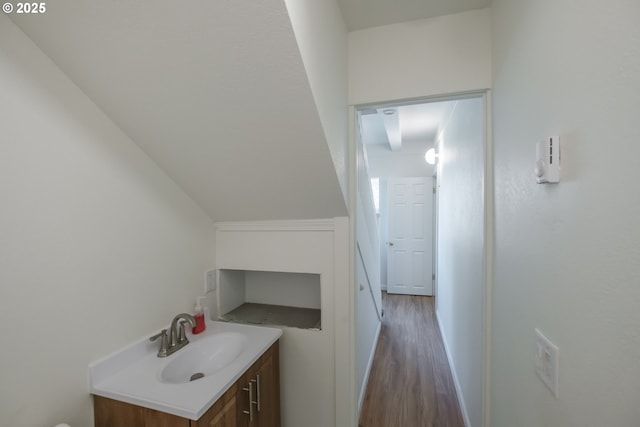 corridor with a sink and wood finished floors