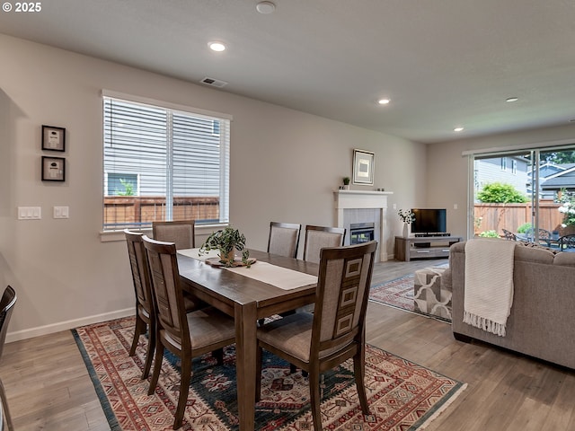 472 SW 16th Ave, Canby, OR 97013 - dining room with light wood finished floors, a tile fireplace, and recessed lighting