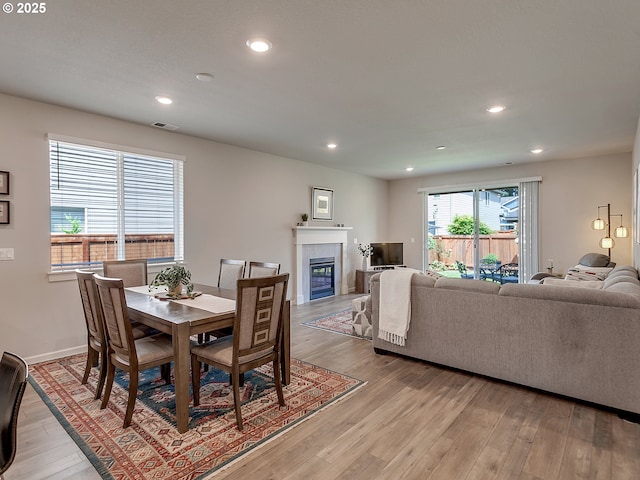472 SW 16th Ave, Canby, OR 97013 - dining space with light wood finished floors, recessed lighting, and a tiled fireplace
