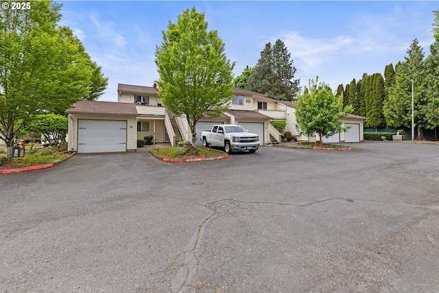 view of front of home featuring a garage and stairway