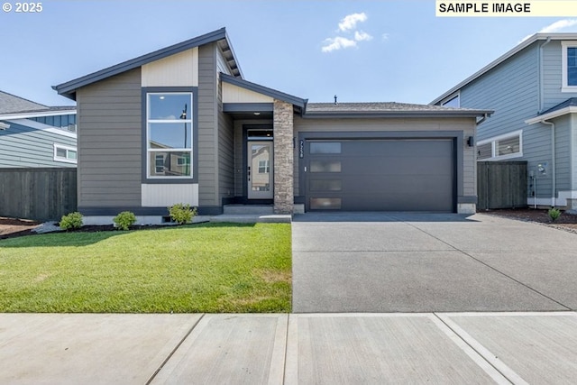 view of front of property with driveway, an attached garage, a front yard, and fence