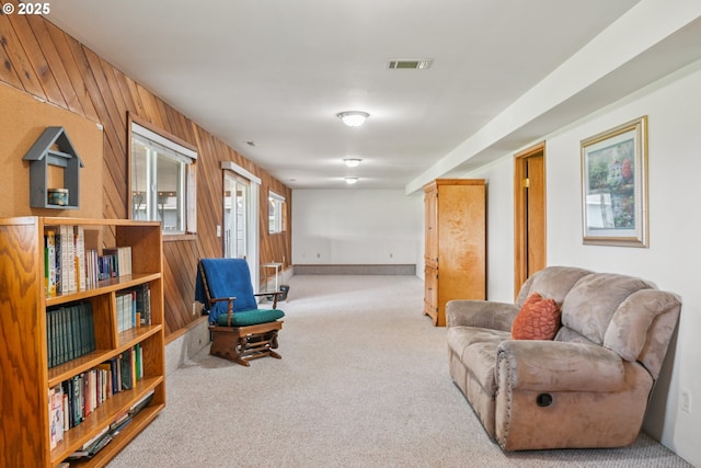 220 Plomondon Rd, Toledo, WA 98591 - living area with wooden walls, baseboards, carpet flooring, and visible vents