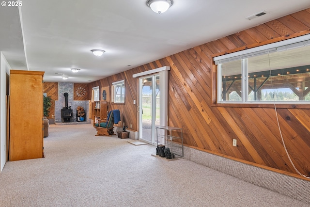220 Plomondon Rd, Toledo, WA 98591 - interior space with a wood stove, carpet flooring, wood walls, and visible vents