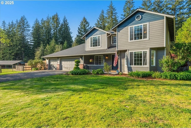 20606 NE 229th St, Battle Ground, WA 98604 - traditional home with fence, aphalt driveway, a garage, a porch, and a front yard