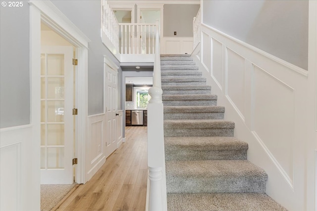 20606 NE 229th St, Battle Ground, WA 98604 - stairs with a wainscoted wall, wood finished floors, and a decorative wall