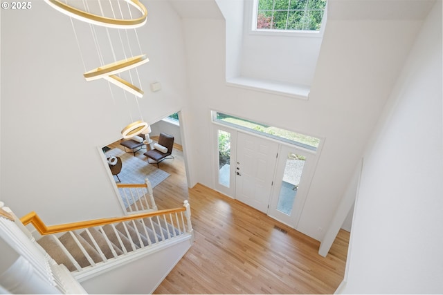 14067 Chatham Ct, Lake Oswego, OR 97035 - entrance foyer with a high ceiling, wood finished floors, and stairs