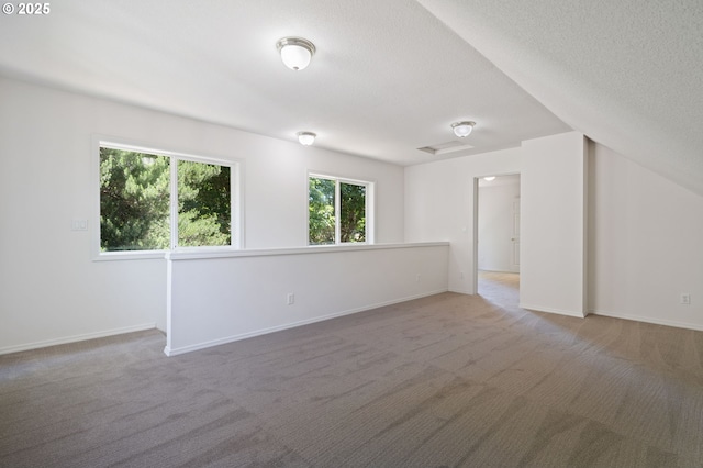 14067 Chatham Ct, Lake Oswego, OR 97035 - carpeted empty room featuring healthy amount of natural light and a textured ceiling