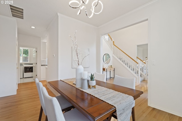 14067 Chatham Ct, Lake Oswego, OR 97035 - dining area featuring a chandelier, stairway, ornamental molding, light wood-style flooring, and recessed lighting