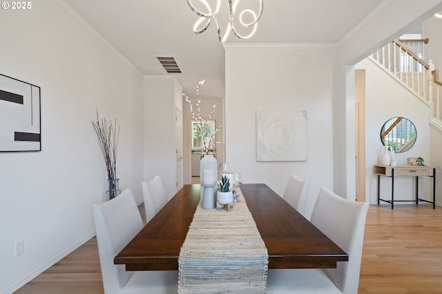 14067 Chatham Ct, Lake Oswego, OR 97035 - dining area featuring a chandelier, light wood-style flooring, crown molding, and stairs