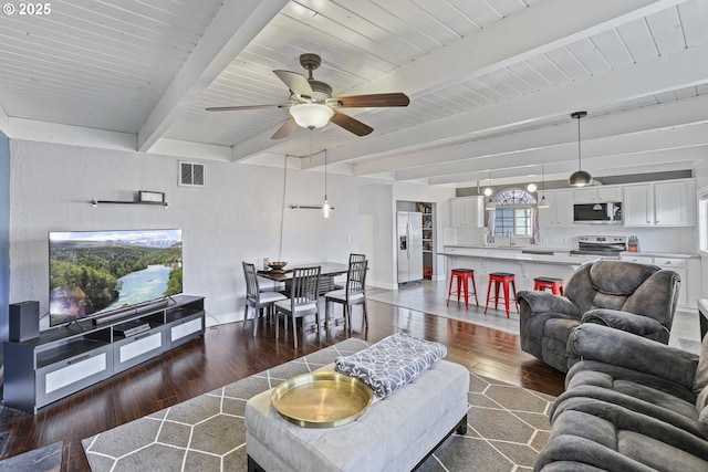 2064 Tualatin St, Saint Helens, OR 97051 - living area featuring dark wood-style floors, a ceiling fan, and beamed ceiling