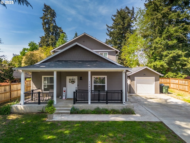 15807 SE Rainier Ave, Clackamas, OR 97015 - view of front of home featuring concrete driveway, an outdoor structure, a porch, and a detached garage