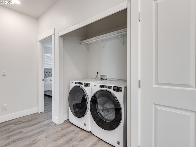 15807 SE Rainier Ave, Clackamas, OR 97015 - laundry room featuring washer and clothes dryer, light wood-style floors, and baseboards