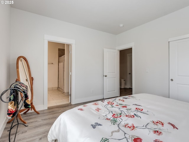 15807 SE Rainier Ave, Clackamas, OR 97015 - bedroom featuring light wood-style floors, baseboards, connected bathroom, and a closet