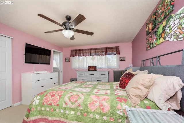 bedroom featuring carpet floors, ceiling fan, multiple windows, and baseboards