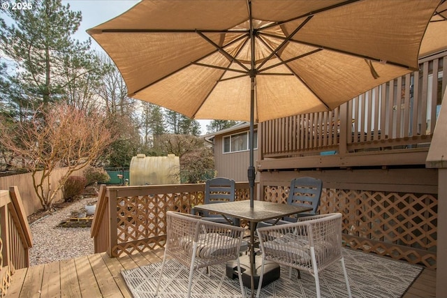 deck featuring outdoor dining space and fence