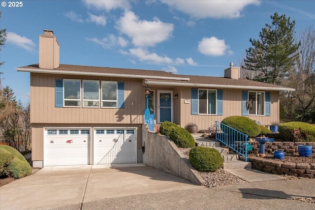 view of front of house featuring concrete driveway, a chimney, and an attached garage