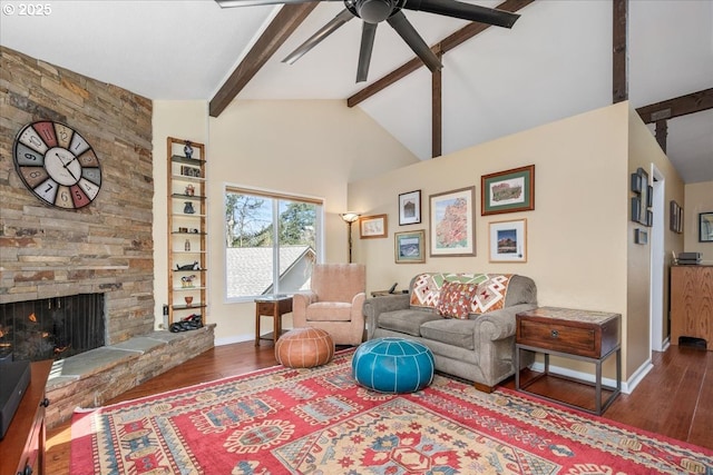 living area with baseboards, a fireplace, beamed ceiling, and wood finished floors